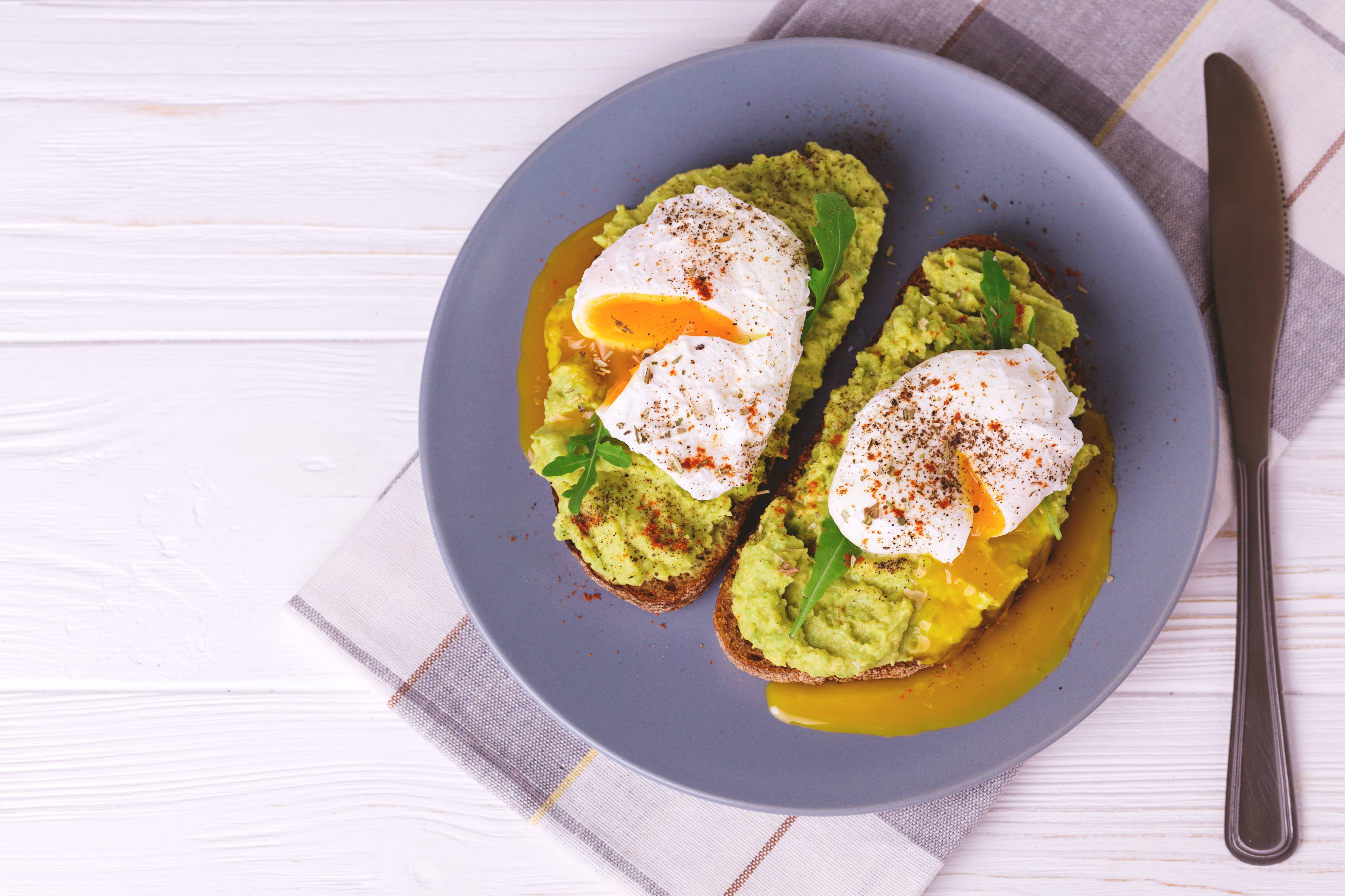 Smashed avocado and poached eggs on toast Flora